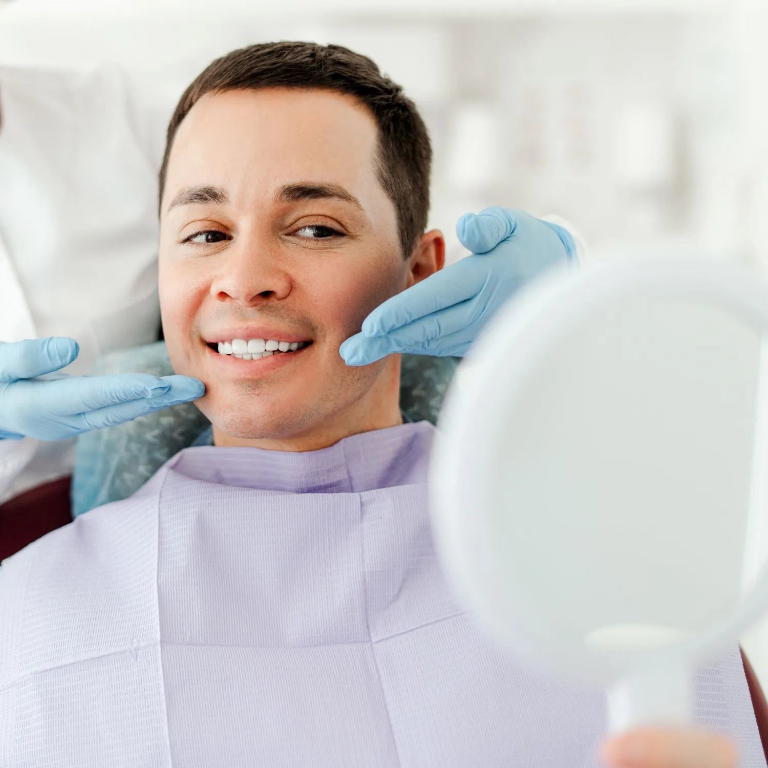 man looking his smile in a mirror
