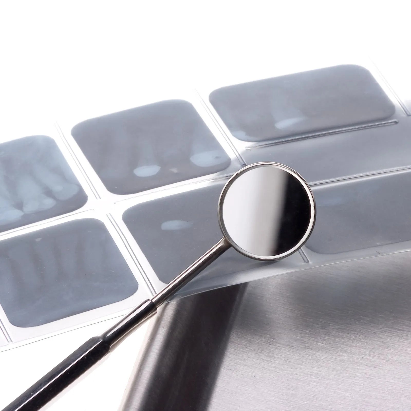 small x-ray on a table and a small mirror for dental examination