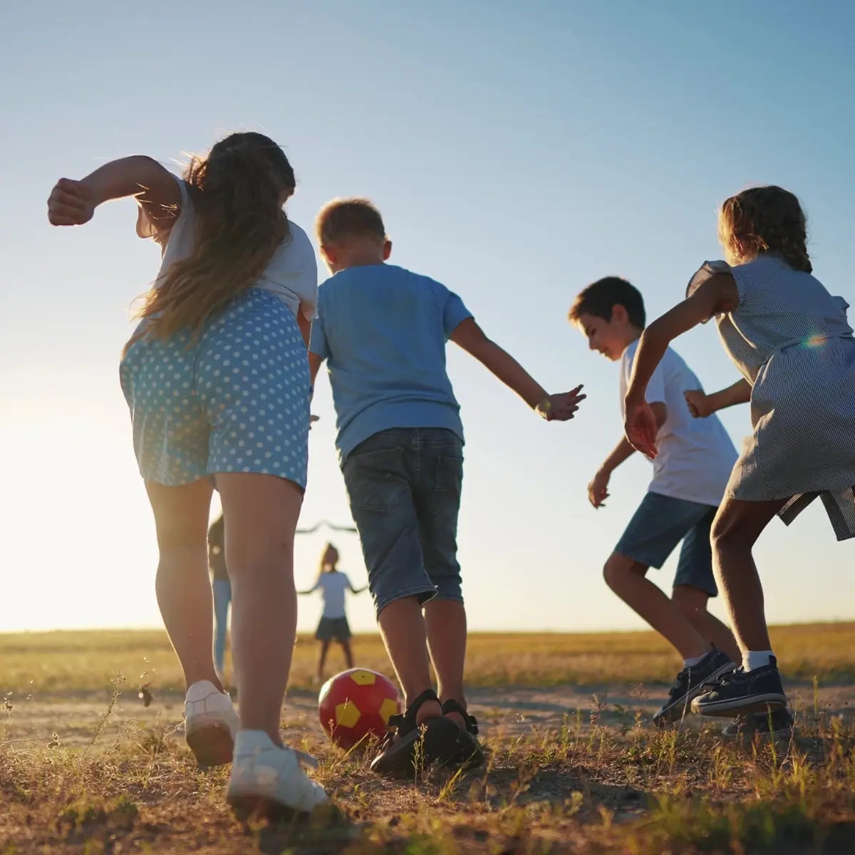 group of children playing in an open field