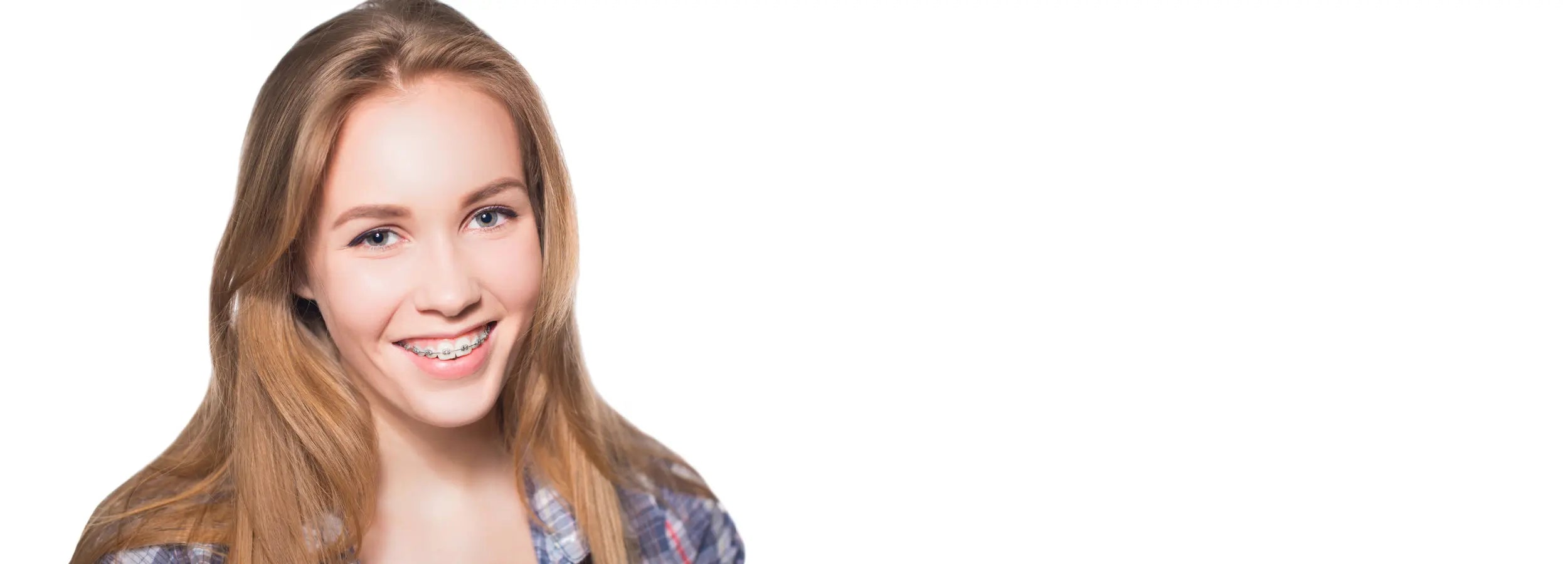 young teenager smiling at canera wearing fixed braces