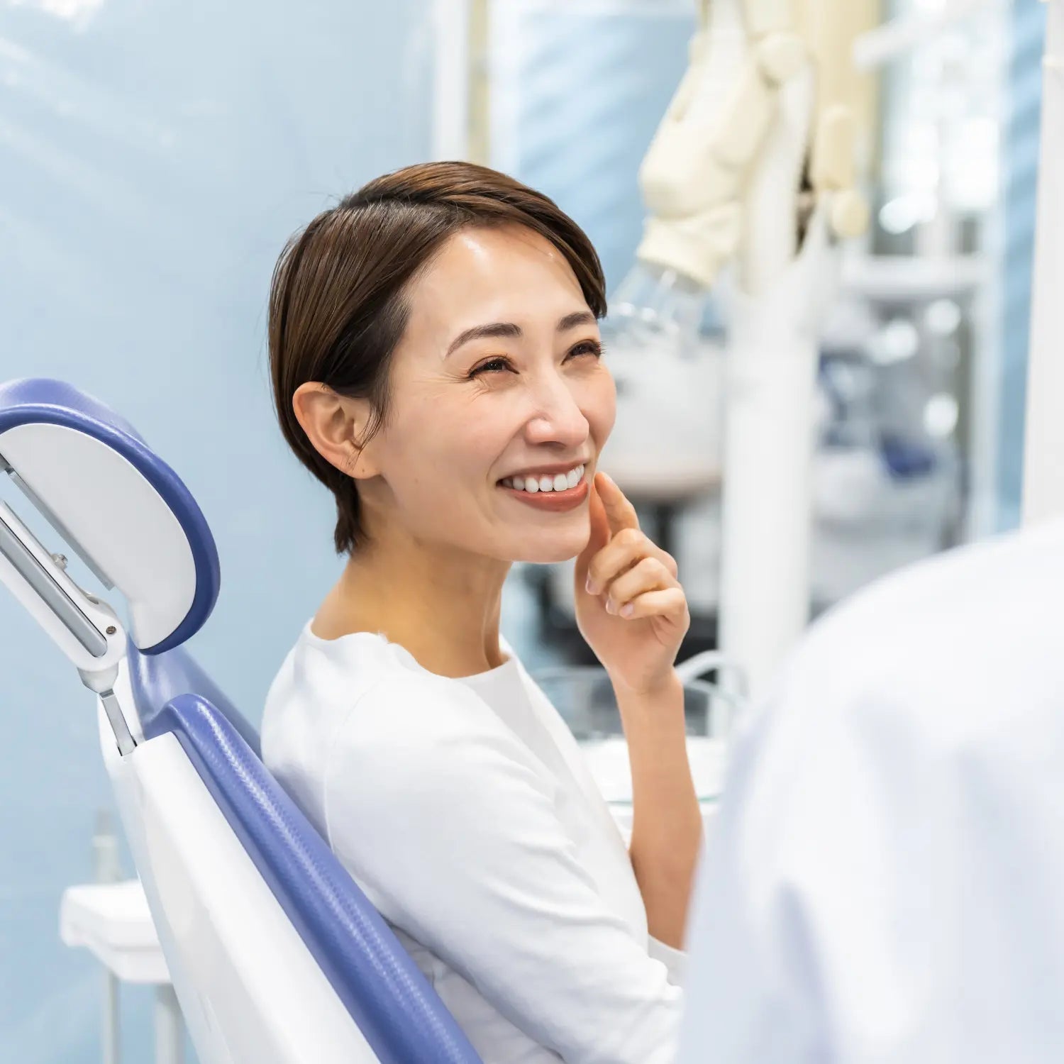 asian woman smiling on a dental chair