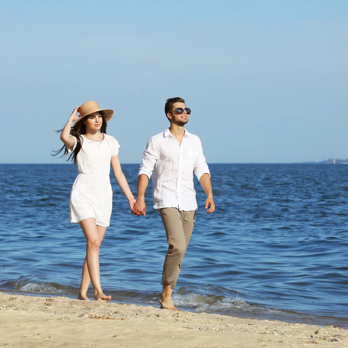 couple enjoying walking along the beach 