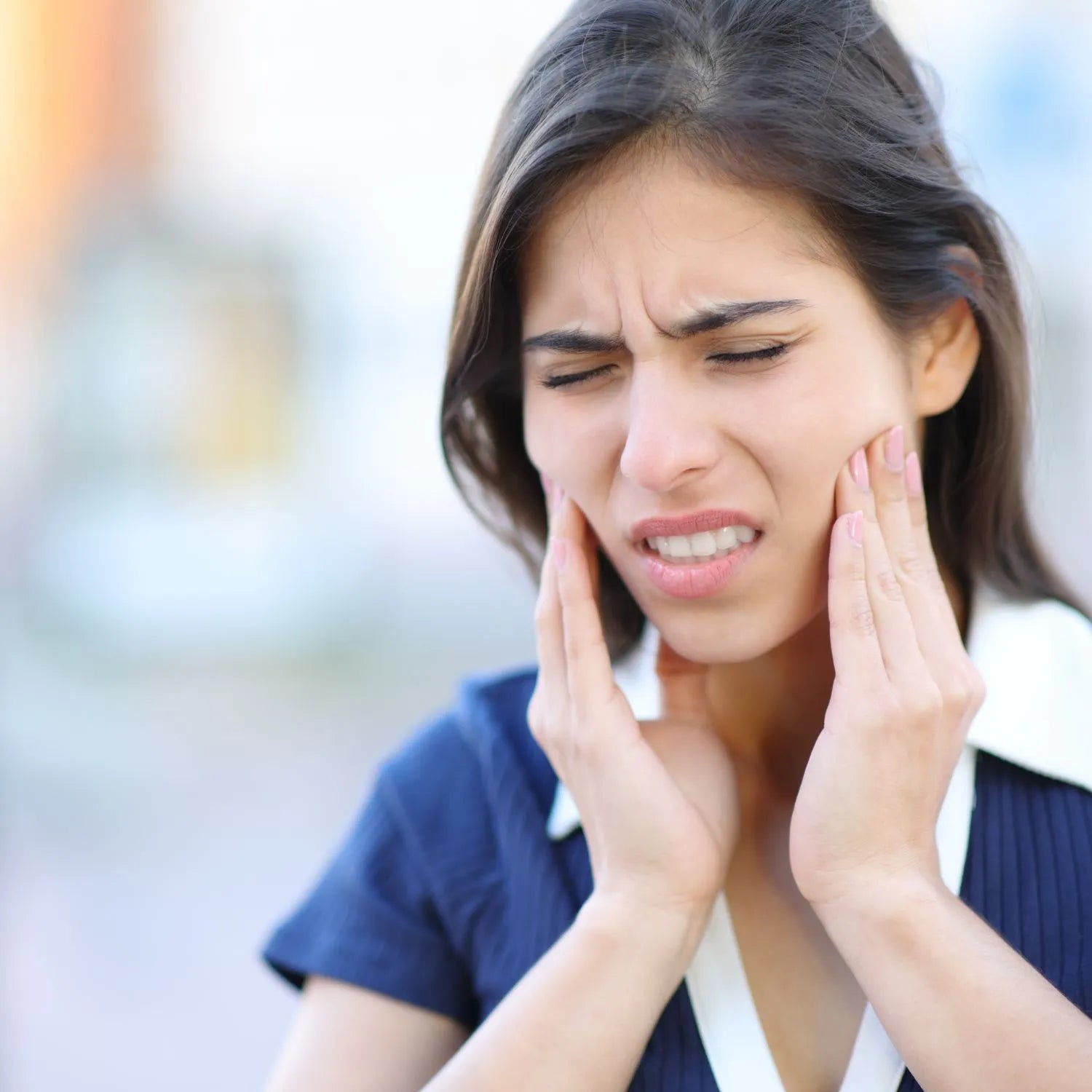 woman with pain on TMJ